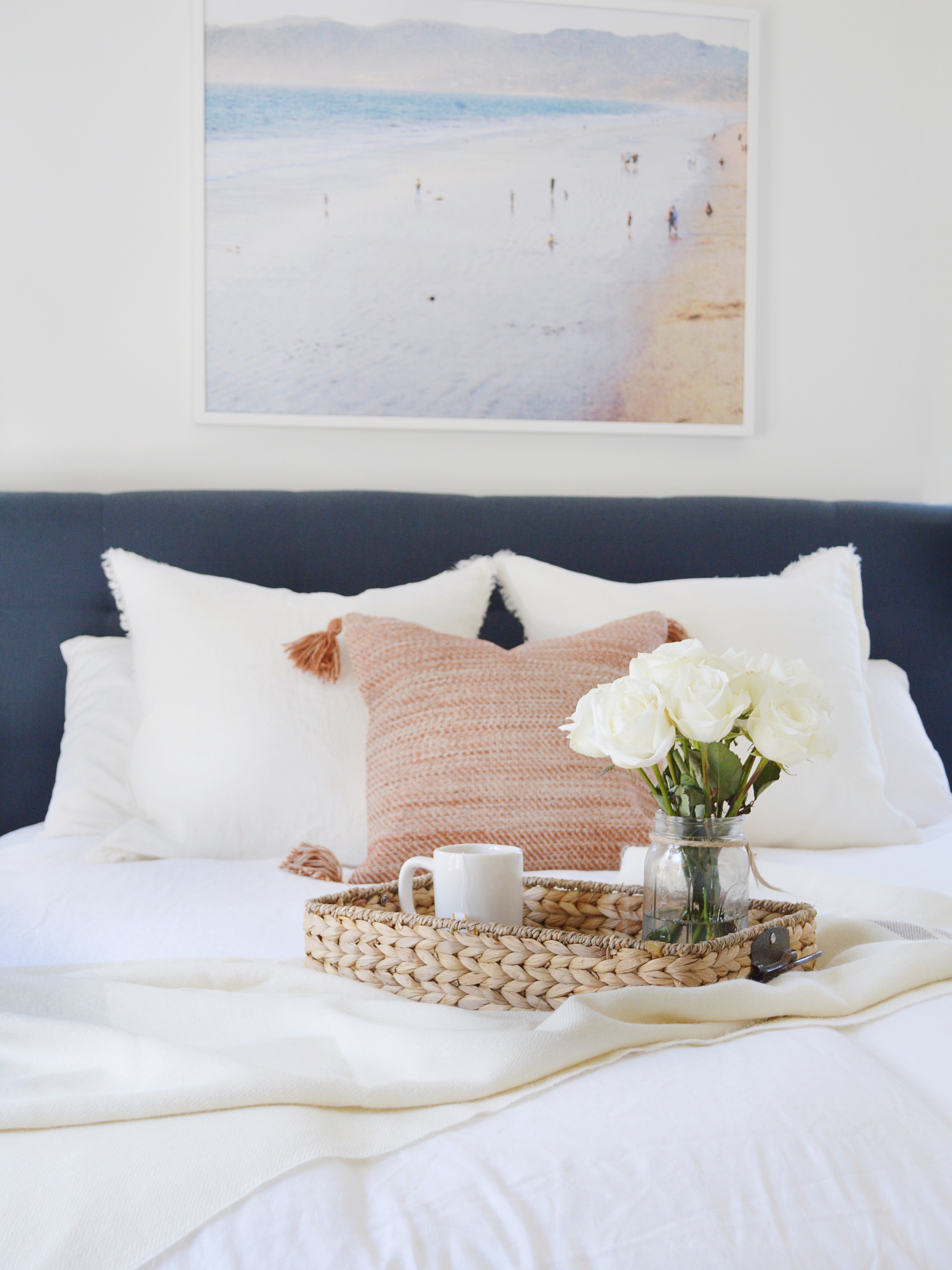 white bedding with throw pillows