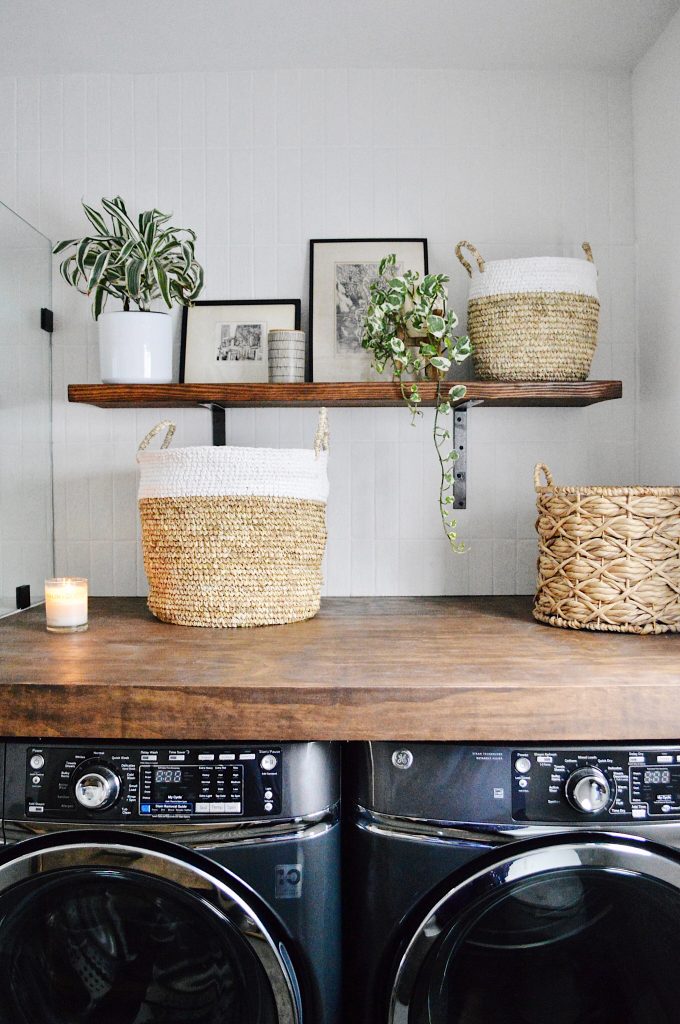 laundry space: DIY plywood and shelf, GE appliances, Bedrosians tile, AllModern baskets and thrifted art