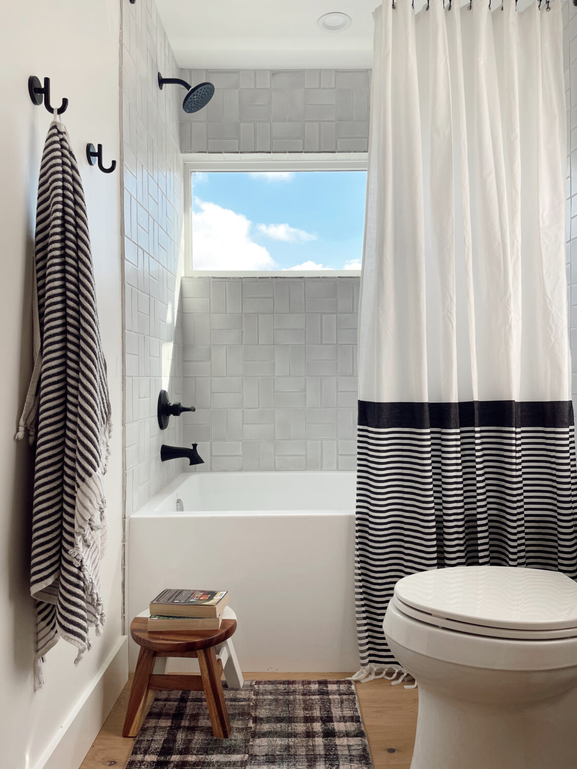 patterned tile, window in the shower, big tub, shower curtain